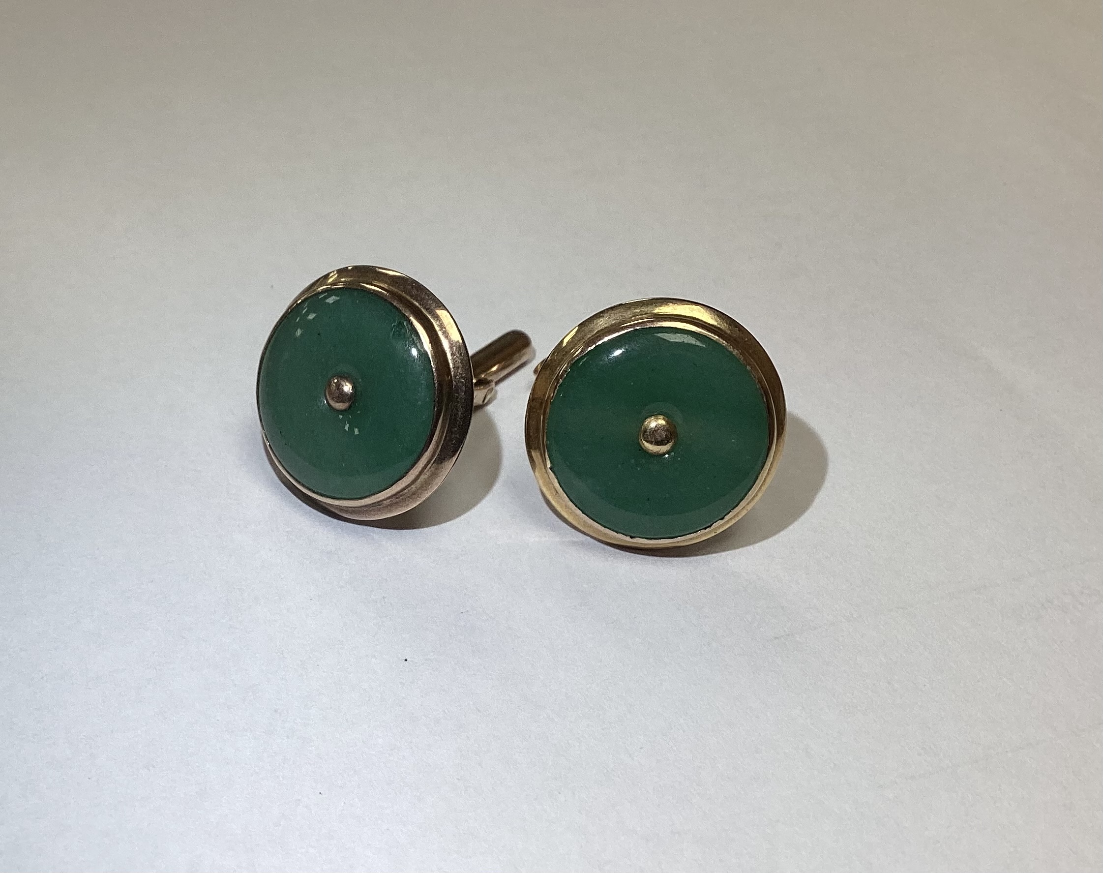 Two pairs of cufflinks, including textured 750 yellow metal 16.5 grams and 9k and jade set disc cufflinks.